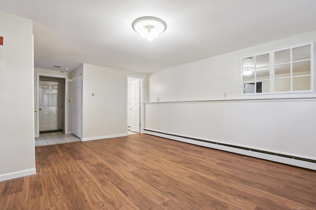 205 Ocean View Ave, Groton, CT 06355 - spare room featuring baseboard heating, baseboards, and wood finished floors