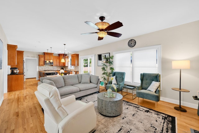 15 Lafountain Rd, Suffield, CT 06078 - living room featuring a ceiling fan, light wood-style floors, and baseboards