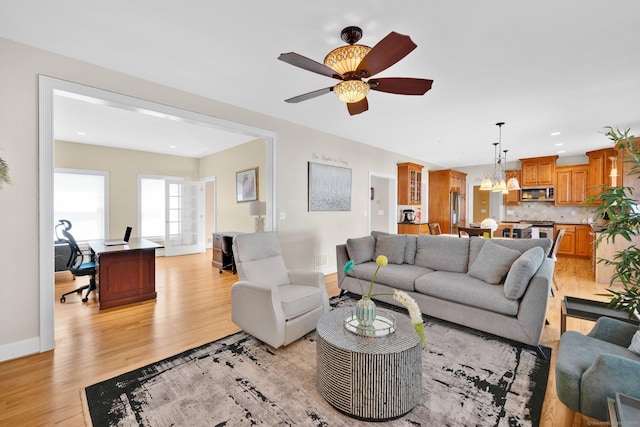 15 Lafountain Rd, Suffield, CT 06078 - living room featuring a chandelier, a desk, light wood-style flooring, ceiling fan, and baseboards