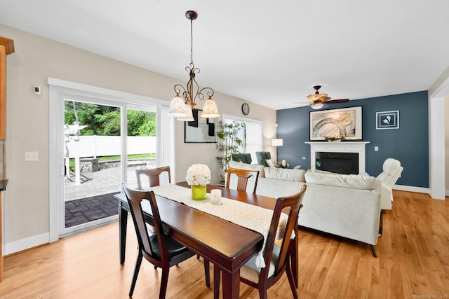 15 Lafountain Rd, Suffield, CT 06078 - dining room featuring ceiling fan, a fireplace, plenty of natural light, and light wood-style floors