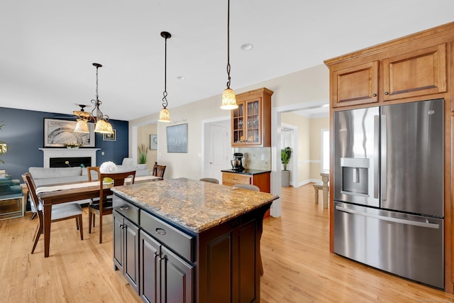 15 Lafountain Rd, Suffield, CT 06078 - kitchen featuring stainless steel refrigerator with ice dispenser, a center island, light wood-style flooring, glass insert cabinets, and hanging light fixtures