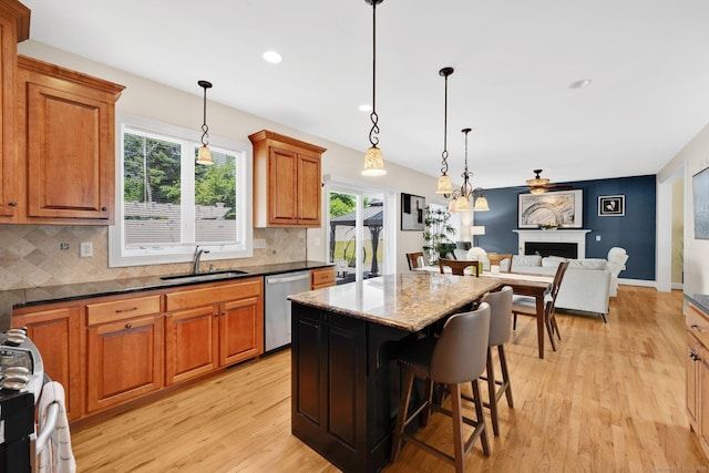 15 Lafountain Rd, Suffield, CT 06078 - kitchen featuring stainless steel dishwasher, a sink, brown cabinetry, healthy amount of natural light, and recessed lighting