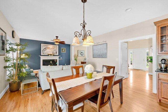 15 Lafountain Rd, Suffield, CT 06078 - dining area with light wood-type flooring, baseboards, a glass covered fireplace, and ceiling fan