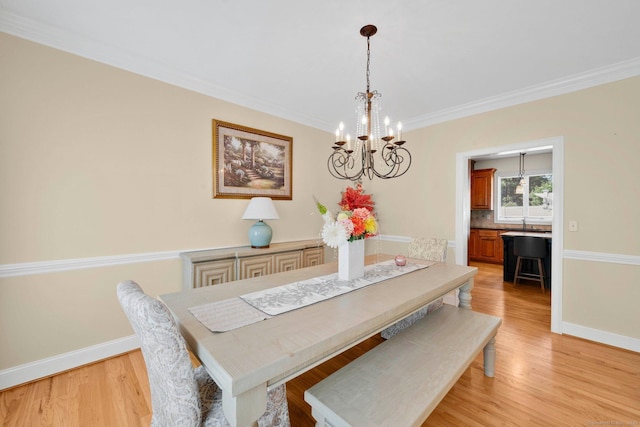 15 Lafountain Rd, Suffield, CT 06078 - dining area featuring a chandelier, baseboards, crown molding, and light wood finished floors