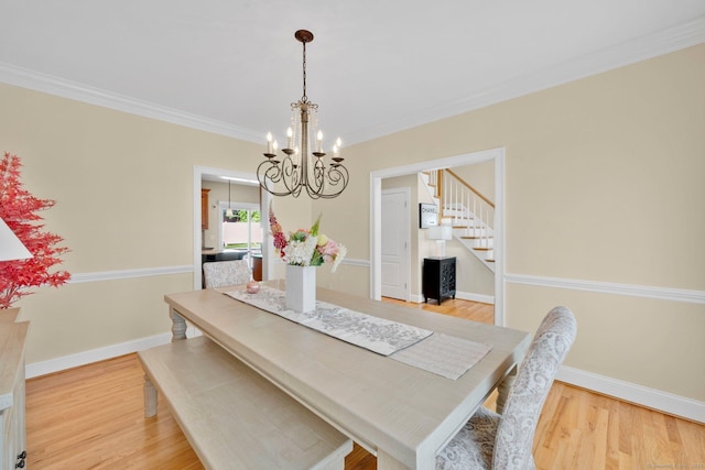 15 Lafountain Rd, Suffield, CT 06078 - dining room with a chandelier, stairway, light wood-style flooring, crown molding, and baseboards