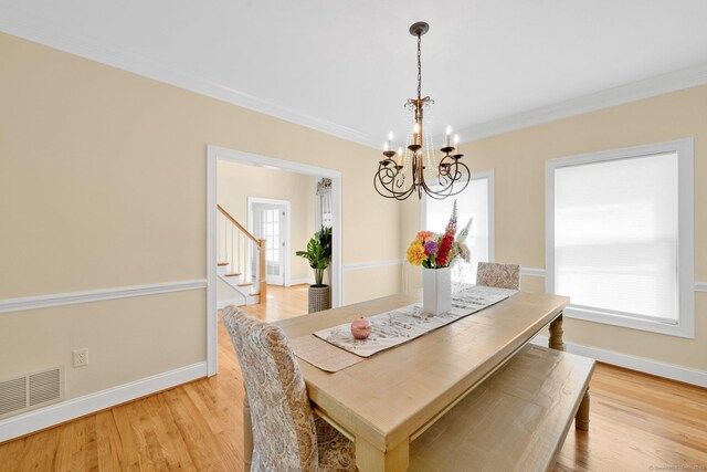 15 Lafountain Rd, Suffield, CT 06078 - dining space with a chandelier, ornamental molding, baseboards, light wood-style floors, and stairway
