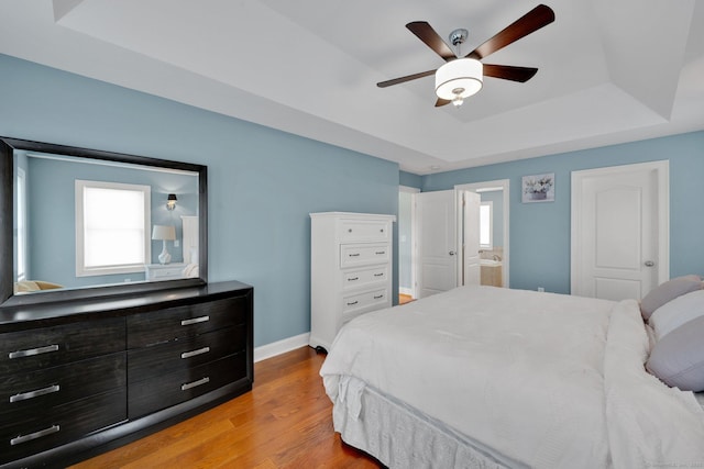 15 Lafountain Rd, Suffield, CT 06078 - bedroom featuring a tray ceiling, baseboards, wood finished floors, connected bathroom, and a ceiling fan