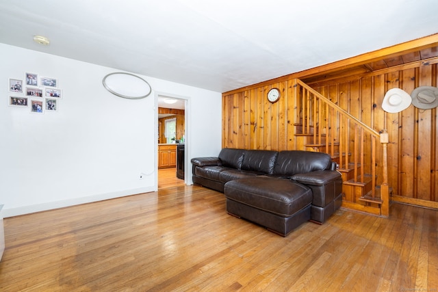 45 Valley Rd, Hamden, CT 06514 - living area with stairs, light wood-style flooring, wooden walls, and baseboards