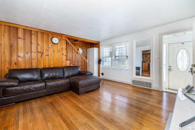 45 Valley Rd, Hamden, CT 06514 - living area with stairs, light wood-type flooring, wood walls, and baseboards