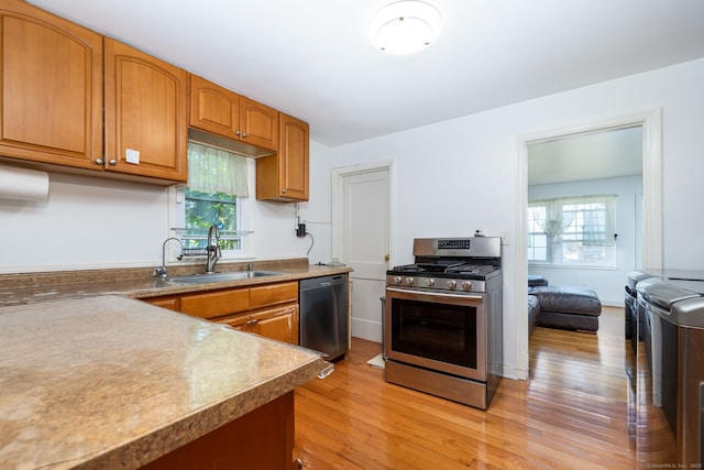 45 Valley Rd, Hamden, CT 06514 - kitchen with stainless steel appliances, a sink, light wood finished floors, and brown cabinetry