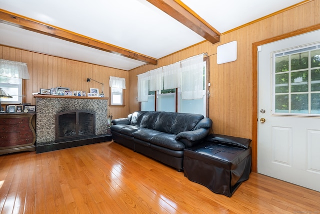 45 Valley Rd, Hamden, CT 06514 - living area with beam ceiling, hardwood / wood-style flooring, a tile fireplace, and wooden walls