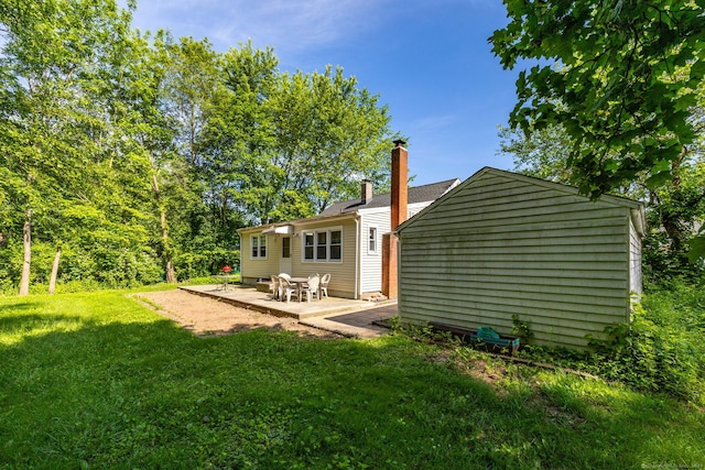 45 Valley Rd, Hamden, CT 06514 - rear view of house featuring a lawn, a chimney, and a patio