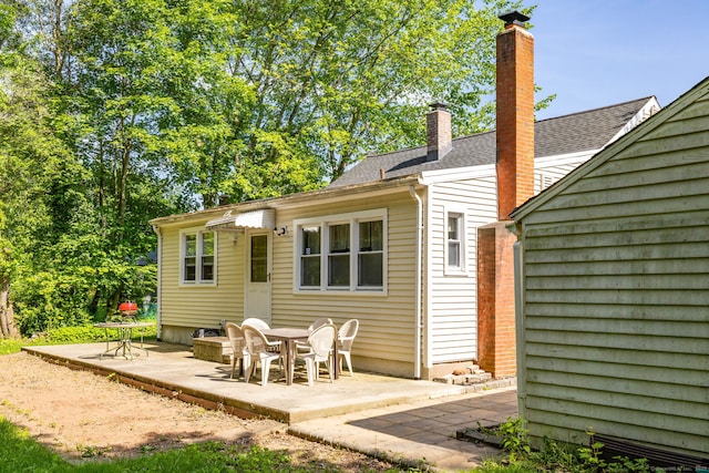 45 Valley Rd, Hamden, CT 06514 - rear view of property featuring a patio area, a chimney, and roof with shingles