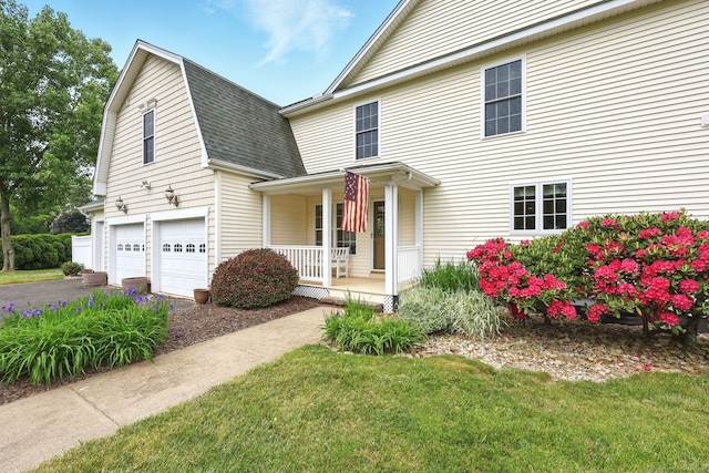 7 Brook Wood Ct, East Windsor, CT 06016 - view of front facade with a porch, a shingled roof, an attached garage, driveway, and a front yard