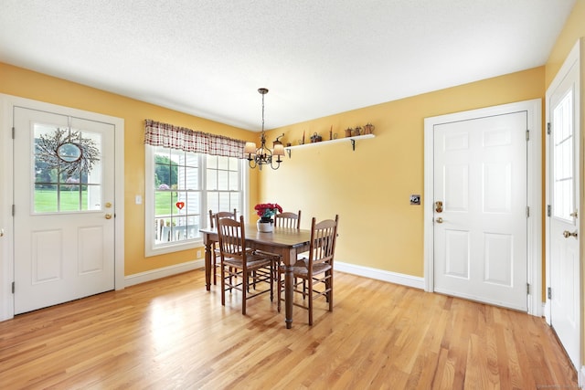 7 Brook Wood Ct, East Windsor, CT 06016 - dining room with a chandelier, light wood-style flooring, and baseboards