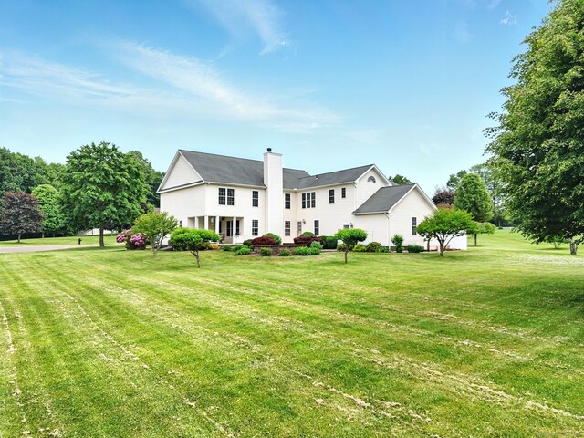 7 Brook Wood Ct, East Windsor, CT 06016 - back of house with a yard and a chimney