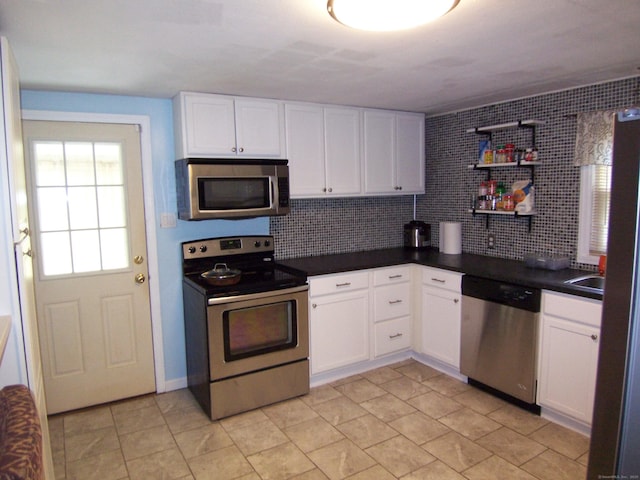 28 Terrace Ave, East Hartford, CT 06108 - kitchen featuring stainless steel appliances, dark countertops, white cabinetry, and decorative backsplash