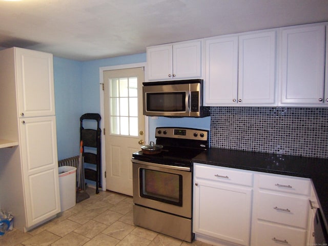 28 Terrace Ave, East Hartford, CT 06108 - kitchen with appliances with stainless steel finishes, white cabinets, backsplash, and dark countertops
