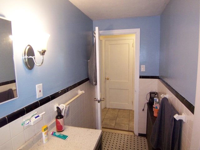 28 Terrace Ave, East Hartford, CT 06108 - bathroom with tile walls, a wainscoted wall, vanity, and tile patterned floors