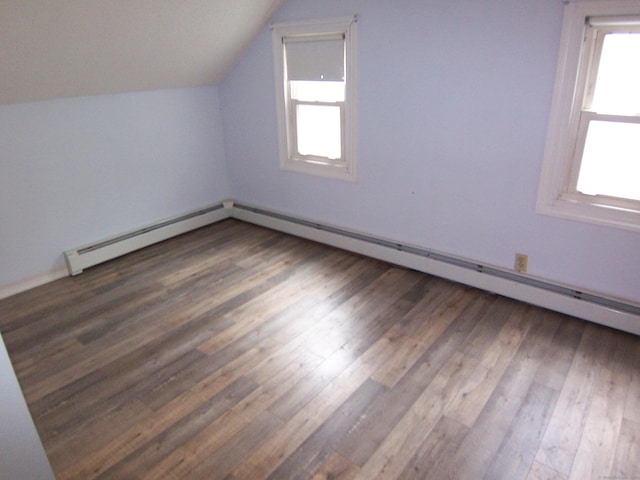 28 Terrace Ave, East Hartford, CT 06108 - additional living space with healthy amount of natural light, lofted ceiling, wood finished floors, and a baseboard heating unit