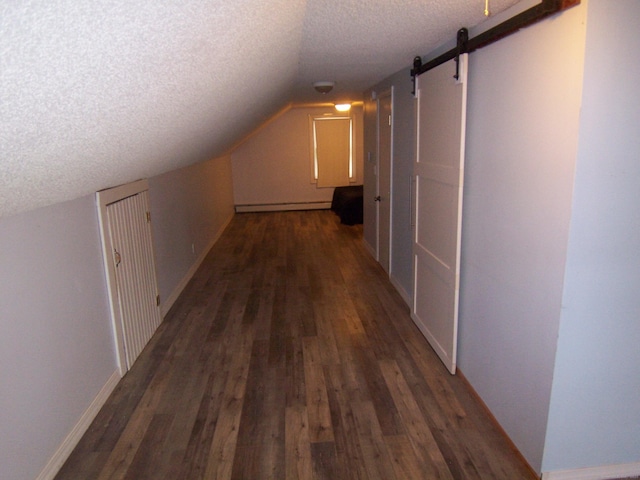 28 Terrace Ave, East Hartford, CT 06108 - bonus room with a textured ceiling, wood finished floors, lofted ceiling, a baseboard heating unit, and a barn door