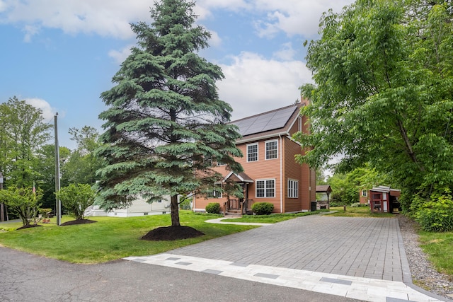 9 Purdum Rd, New Fairfield, CT 06812 - view of front facade with solar panels, driveway, and a front lawn