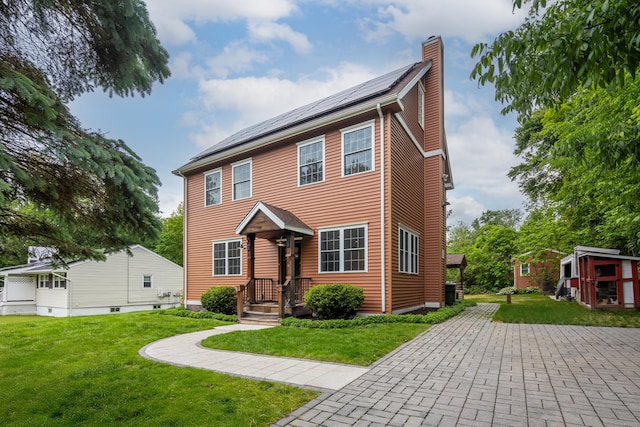 9 Purdum Rd, New Fairfield, CT 06812 - view of front facade featuring a chimney, a front lawn, and solar panels