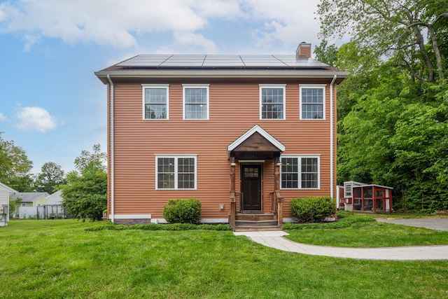 9 Purdum Rd, New Fairfield, CT 06812 - view of front facade featuring solar panels, a chimney, and a front lawn