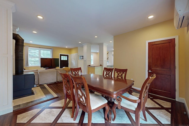 9 Purdum Rd, New Fairfield, CT 06812 - dining space featuring a wall unit AC, inlaid floor details, recessed lighting, a wood stove, and baseboards