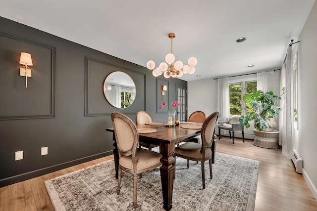 89 Goose Green Rd, Barkhamsted, CT 06063 - dining area with a chandelier, light wood finished floors, baseboard heating, baseboards, and a baseboard radiator