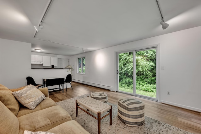 89 Goose Green Rd, Barkhamsted, CT 06063 - living area with rail lighting, a baseboard heating unit, light wood-style flooring, and baseboards