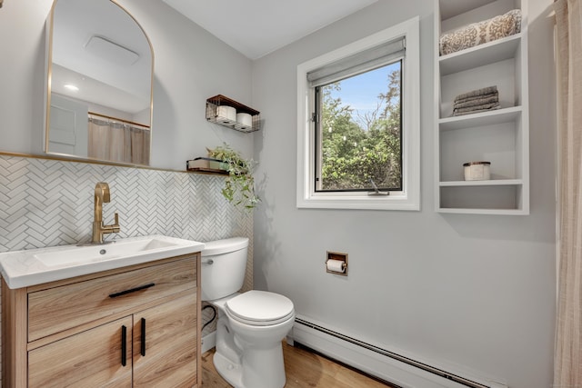 89 Goose Green Rd, Barkhamsted, CT 06063 - full bathroom featuring baseboard heating, vanity, toilet, backsplash, and wood finished floors