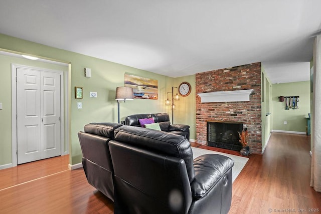 525 Park Ave, Windsor, CT 06095 - living area featuring wood finished floors, a fireplace, and baseboards