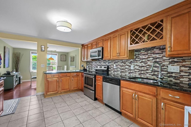 525 Park Ave, Windsor, CT 06095 - kitchen with appliances with stainless steel finishes, a sink, decorative backsplash, and brown cabinetry