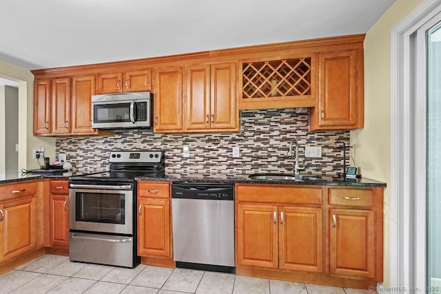 525 Park Ave, Windsor, CT 06095 - kitchen featuring stainless steel appliances, a sink, tasteful backsplash, and dark stone countertops