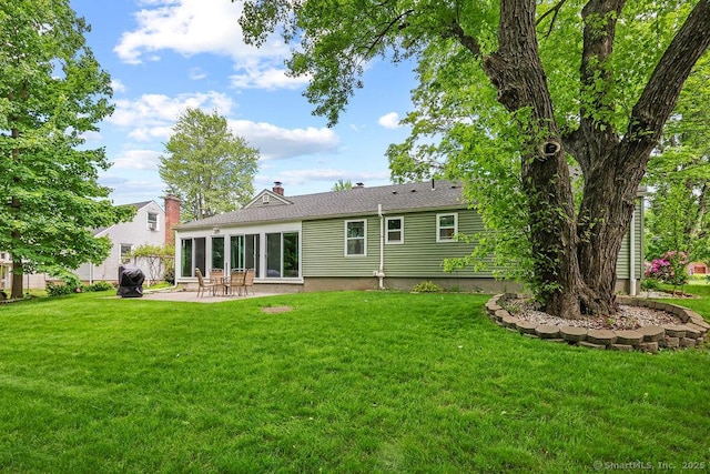 525 Park Ave, Windsor, CT 06095 - back of property featuring a patio area, a lawn, and a chimney