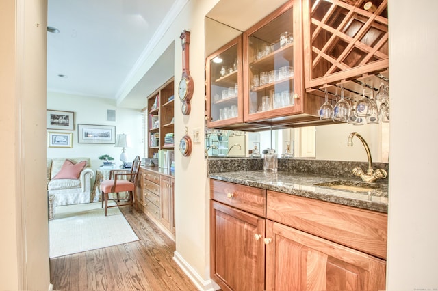 510 W Lyon Farm Dr Unit 510, Greenwich, CT 06831 - bar with crown molding, a sink, and light wood-type flooring