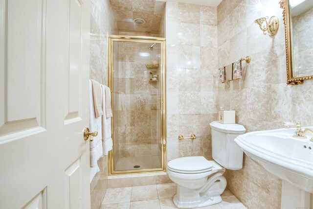 510 W Lyon Farm Dr Unit 510, Greenwich, CT 06831 - full bathroom with a stall shower, toilet, tile patterned floors, tile walls, and a sink