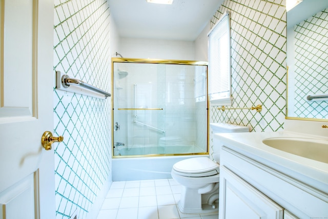 510 W Lyon Farm Dr Unit 510, Greenwich, CT 06831 - bathroom featuring toilet, tile patterned flooring, combined bath / shower with glass door, vanity, and tile walls