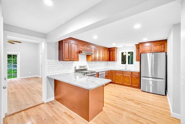 53 Windham Rd, Hampton, CT 06247 - kitchen featuring appliances with stainless steel finishes, a sink, under cabinet range hood, brown cabinetry, and light stone counters