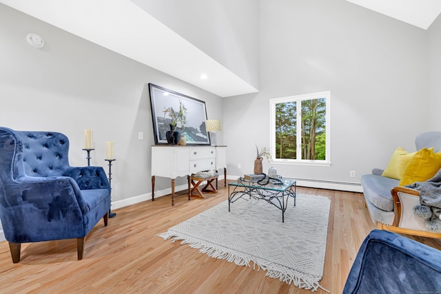 53 Windham Rd, Hampton, CT 06247 - living room featuring baseboard heating, wood finished floors, baseboards, and high vaulted ceiling