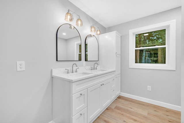 53 Windham Rd, Hampton, CT 06247 - bathroom with baseboards, double vanity, and wood finished floors