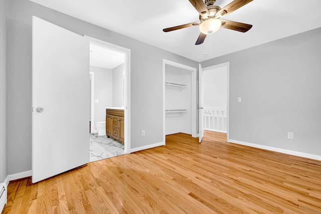 53 Windham Rd, Hampton, CT 06247 - unfurnished bedroom with baseboards, connected bathroom, light wood-style flooring, a closet, and baseboard heating