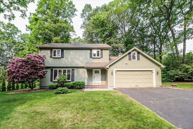 8 Autumn Ln, Plainville, CT 06062 - view of front facade with driveway, an attached garage, and a front lawn