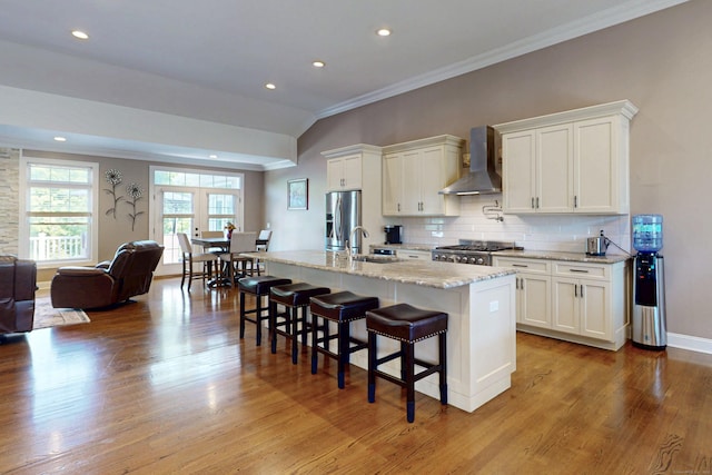 125 Stadley Rough Rd, Danbury, CT 06811 - kitchen featuring wall chimney range hood, stainless steel refrigerator with ice dispenser, ornamental molding, a breakfast bar area, and white cabinets