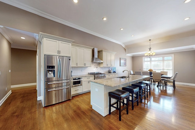 125 Stadley Rough Rd, Danbury, CT 06811 - kitchen featuring appliances with stainless steel finishes, wall chimney exhaust hood, a kitchen bar, baseboards, and ornamental molding