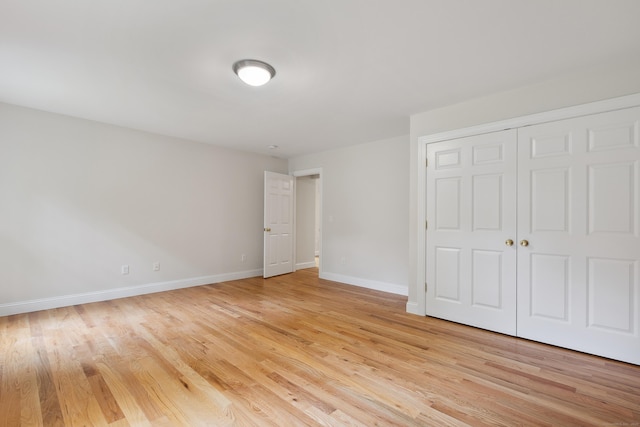 24 Pine Mountain Rd, Redding, CT 06896 - unfurnished bedroom featuring light wood finished floors, baseboards, and a closet