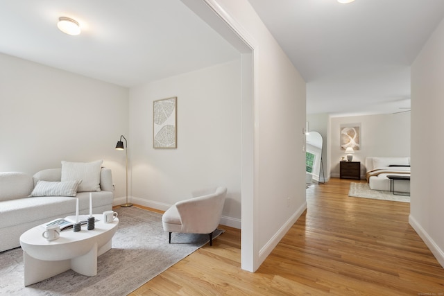24 Pine Mountain Rd, Redding, CT 06896 - living room featuring light wood-style floors, baseboards, and arched walkways