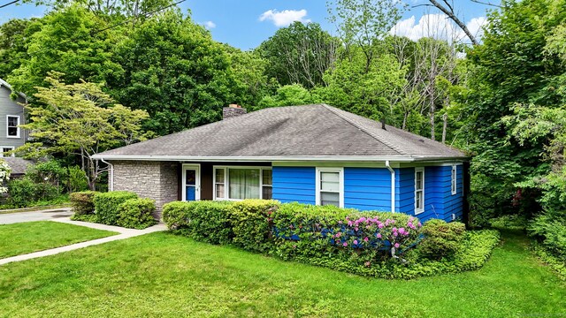 5 Reservoir Rd, Norwich, CT 06360 - view of front facade with a chimney, a front yard, and roof with shingles