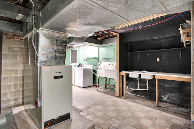 5 Reservoir Rd, Norwich, CT 06360 - unfinished basement featuring washer and dryer, a sink, heating unit, and concrete block wall
